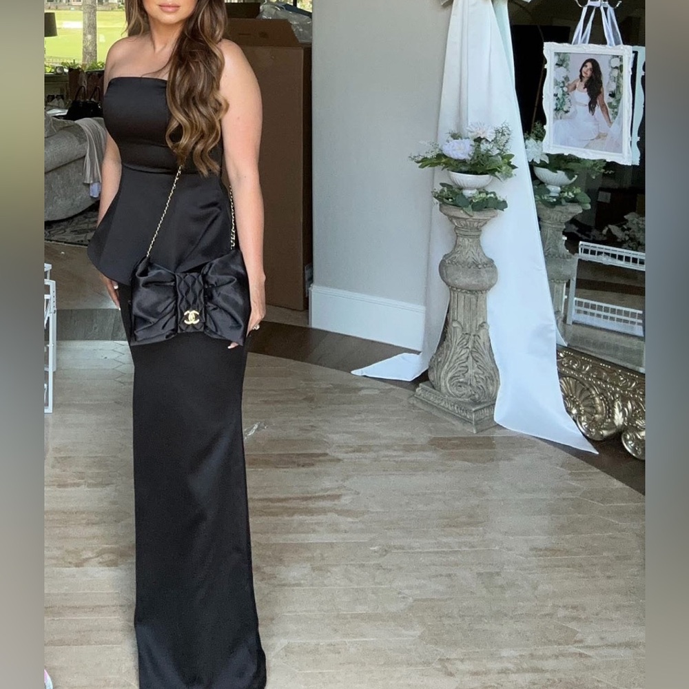 New still in packaging never opened Black gown size Medium